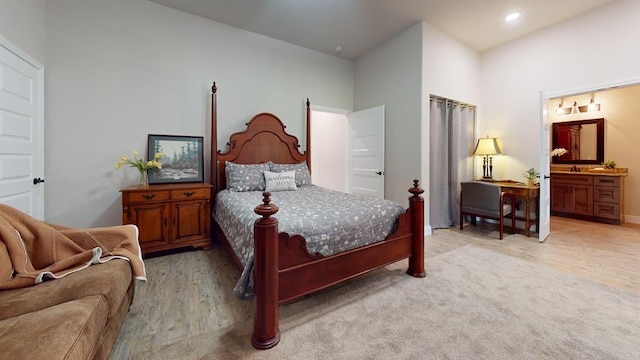 carpeted bedroom featuring ensuite bathroom