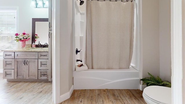 full bathroom with toilet, shower / bath combo with shower curtain, vanity, and hardwood / wood-style flooring