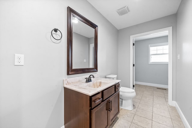 bathroom with vanity, toilet, and tile patterned floors