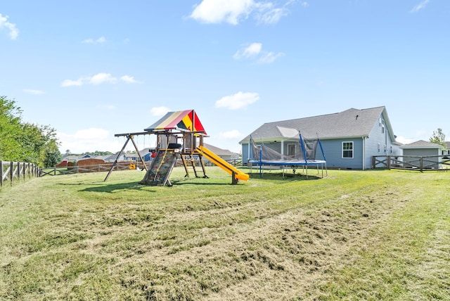 view of play area with a trampoline and a yard