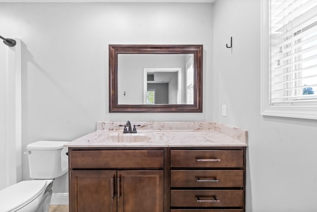 bathroom featuring vanity, tile patterned flooring, and toilet