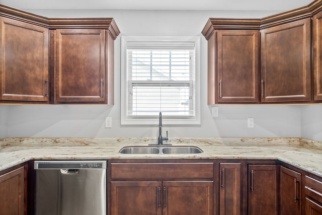 kitchen with dishwasher, light stone counters, and sink