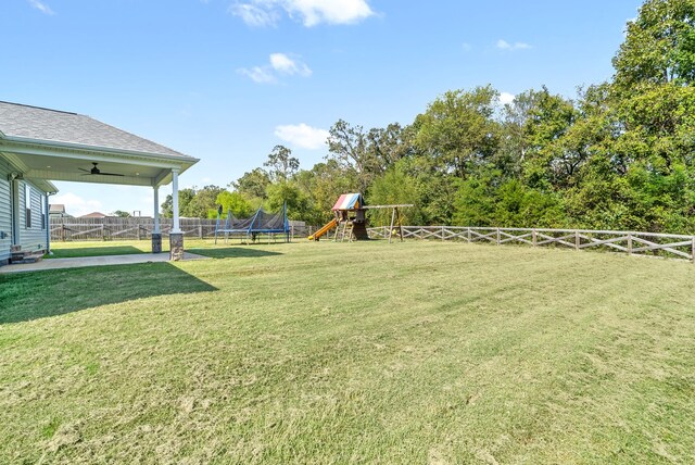 view of yard with a playground and ceiling fan