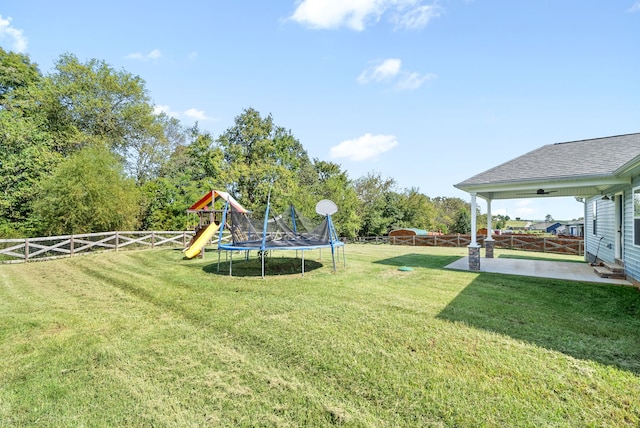 view of yard featuring a playground and a patio