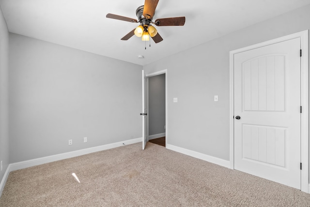 unfurnished bedroom featuring ceiling fan and carpet floors