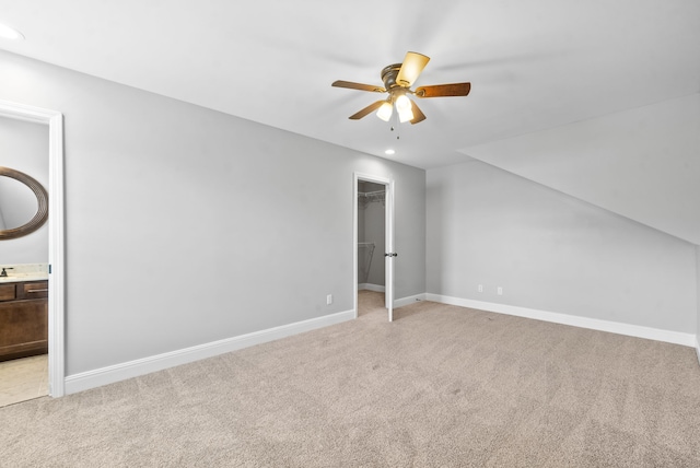 additional living space featuring light carpet and ceiling fan