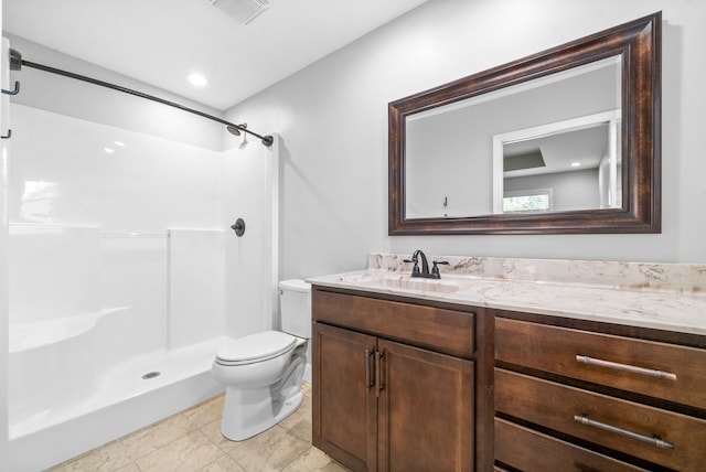 bathroom with tile patterned flooring, a shower, vanity, and toilet