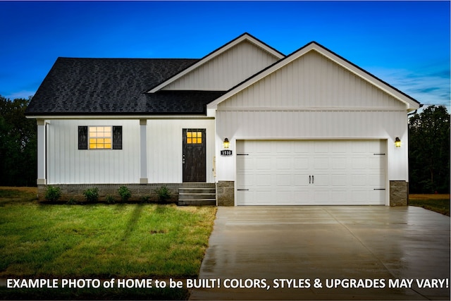 view of front of property featuring a garage and a front yard