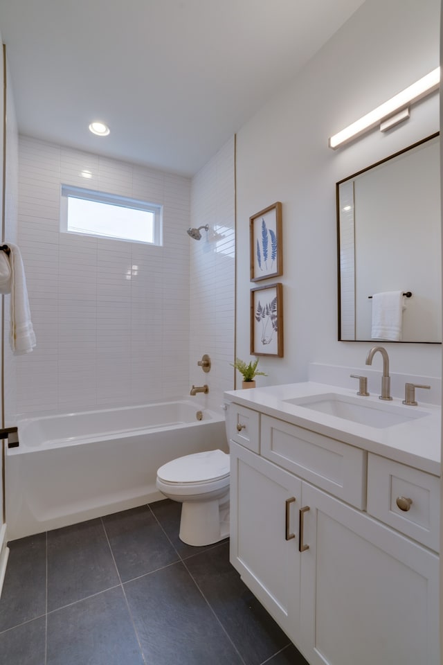 full bathroom featuring vanity, toilet, tile patterned floors, and tiled shower / bath