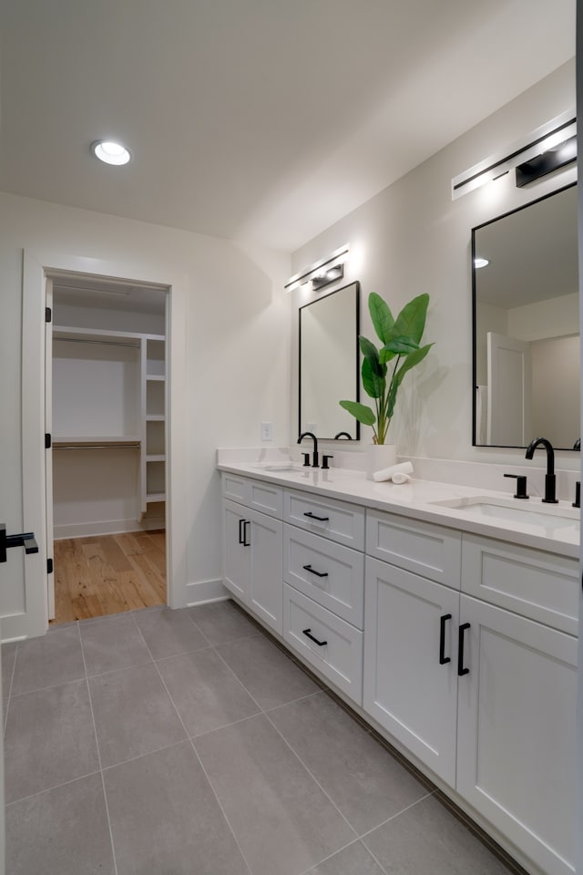 bathroom with tile patterned flooring and vanity