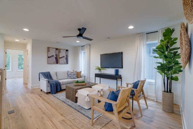 living room with light wood-type flooring and ceiling fan