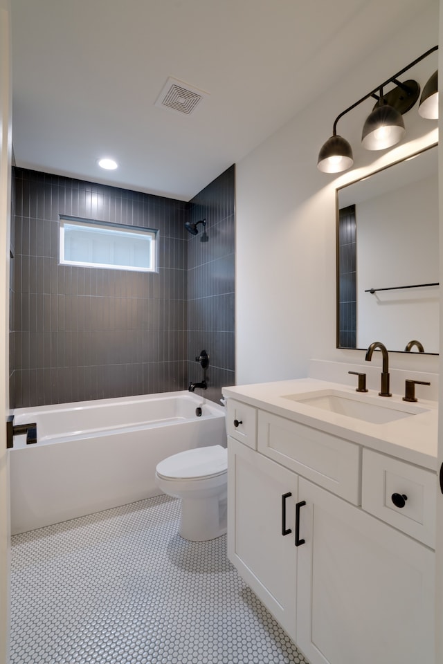 full bathroom with tile patterned flooring, vanity, toilet, and tiled shower / bath