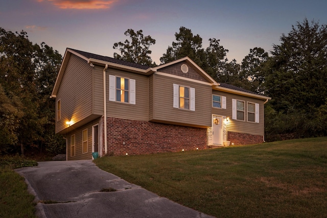 bi-level home with a lawn