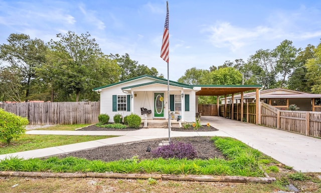 view of front of house with a porch and a carport