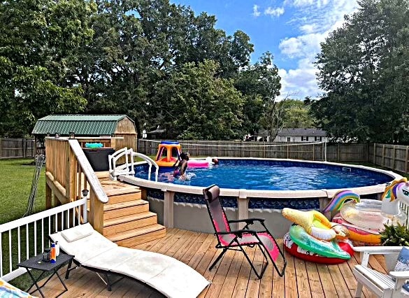 view of pool featuring a deck and a shed