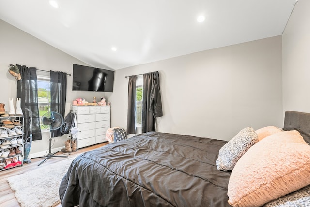 bedroom featuring lofted ceiling and hardwood / wood-style floors