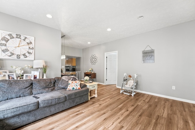 living room featuring a textured ceiling and hardwood / wood-style floors