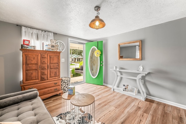 sitting room with a textured ceiling and hardwood / wood-style floors