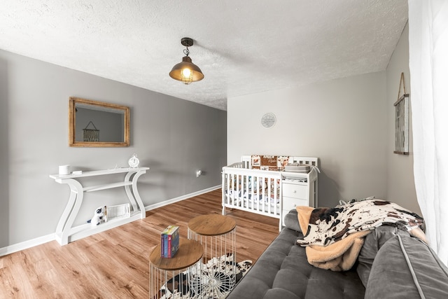 bedroom with a textured ceiling and hardwood / wood-style flooring