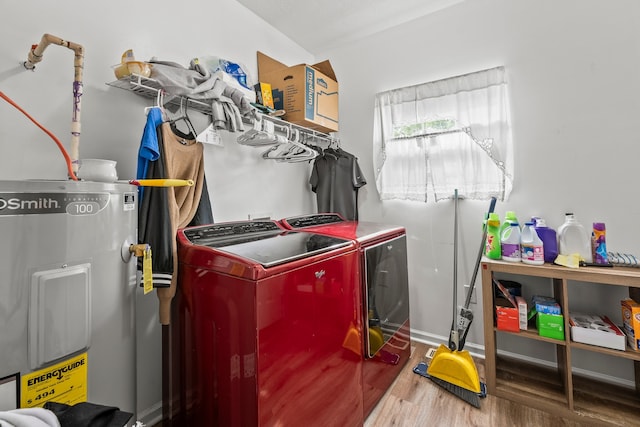 clothes washing area with wood-type flooring, water heater, and independent washer and dryer