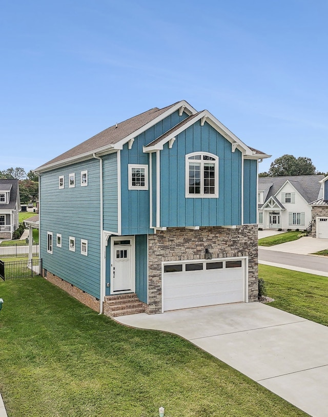 view of front of house featuring a garage and a front lawn