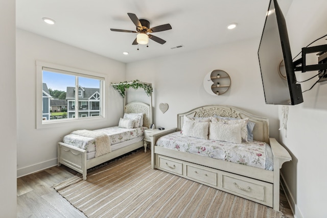 bedroom with ceiling fan and light hardwood / wood-style flooring