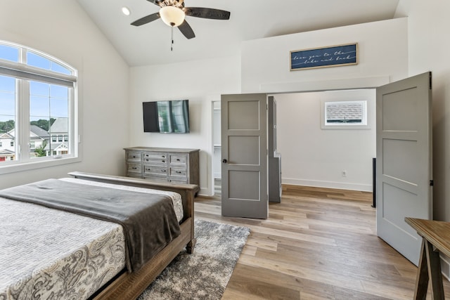 bedroom featuring ceiling fan, light hardwood / wood-style floors, and vaulted ceiling