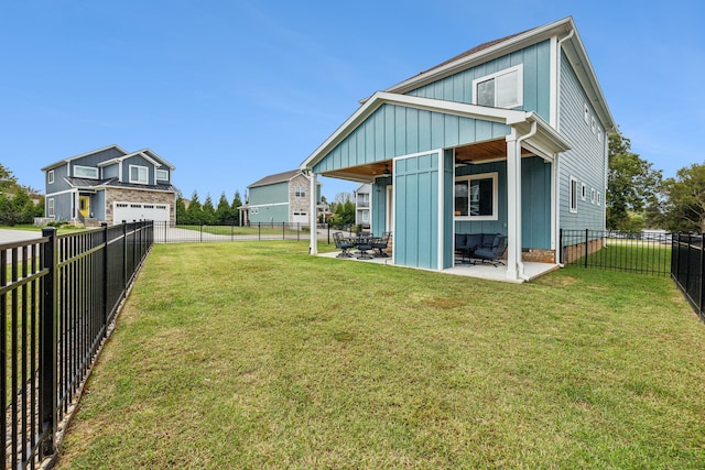 rear view of house with a yard and a patio