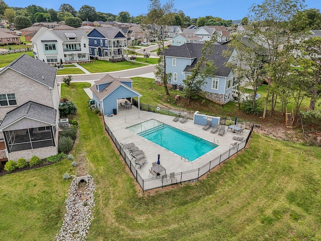 view of pool with a patio and a yard