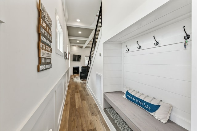 mudroom featuring beamed ceiling and hardwood / wood-style flooring