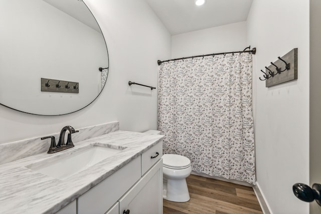 bathroom with wood-type flooring, vanity, toilet, and a shower with shower curtain