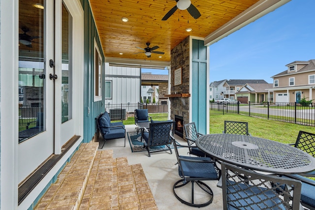 sunroom / solarium with ceiling fan and wood ceiling