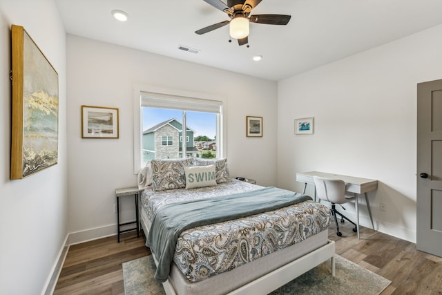 bedroom with dark hardwood / wood-style floors and ceiling fan