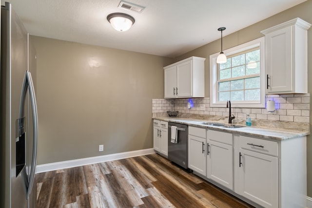 kitchen with white cabinets, appliances with stainless steel finishes, and sink