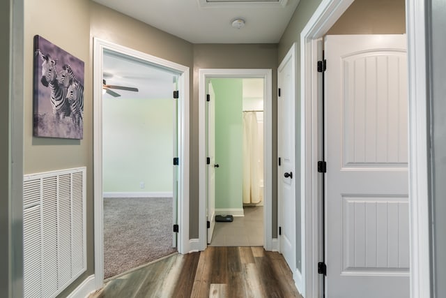 corridor with dark wood-type flooring