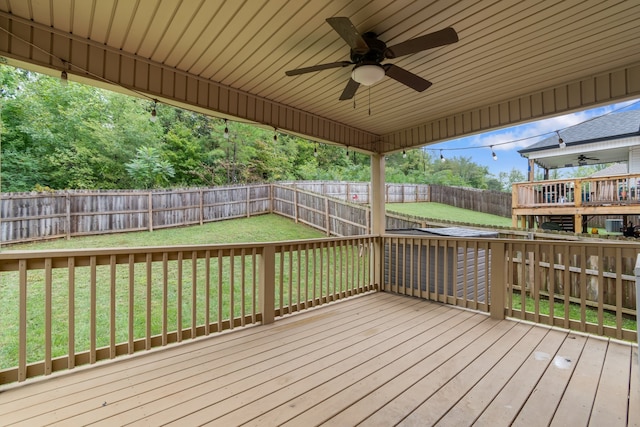 deck featuring ceiling fan and a yard