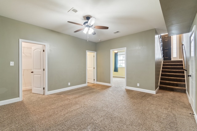 carpeted empty room with ceiling fan