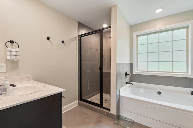 bathroom with plus walk in shower, tile patterned floors, and vanity