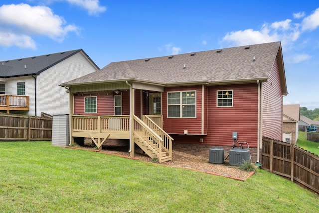 back of property featuring central AC, a deck, and a yard