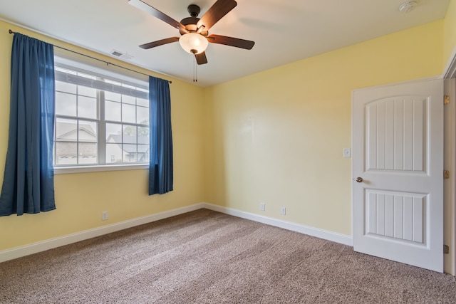 carpeted empty room featuring ceiling fan