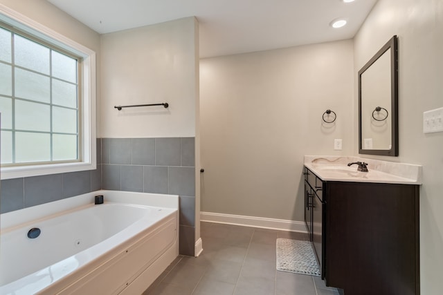 bathroom with vanity, a bathing tub, and tile patterned floors