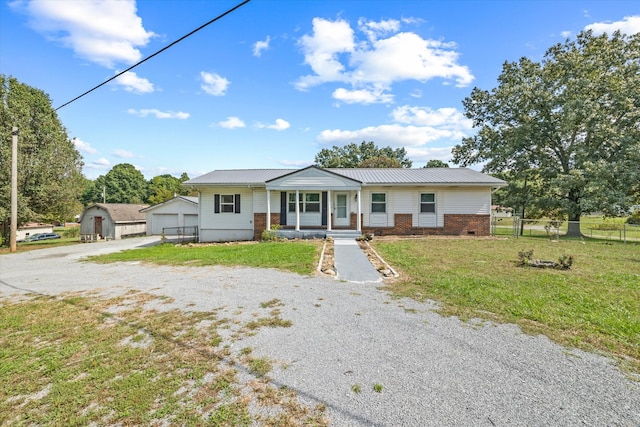 view of front of property with a storage shed and a front yard