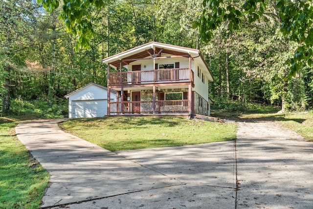 front facade featuring a front yard, an outbuilding, and a garage