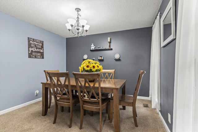 dining space featuring a textured ceiling, a chandelier, and carpet