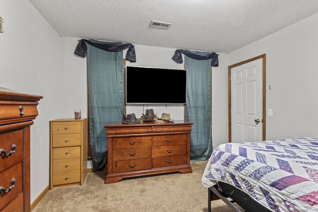 carpeted bedroom with a textured ceiling