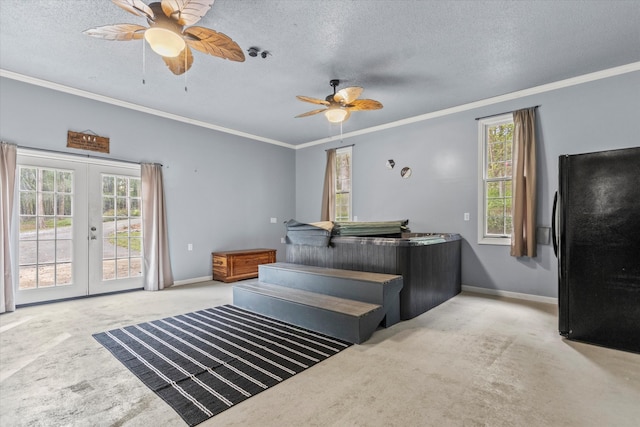 bedroom featuring light carpet, a textured ceiling, and french doors