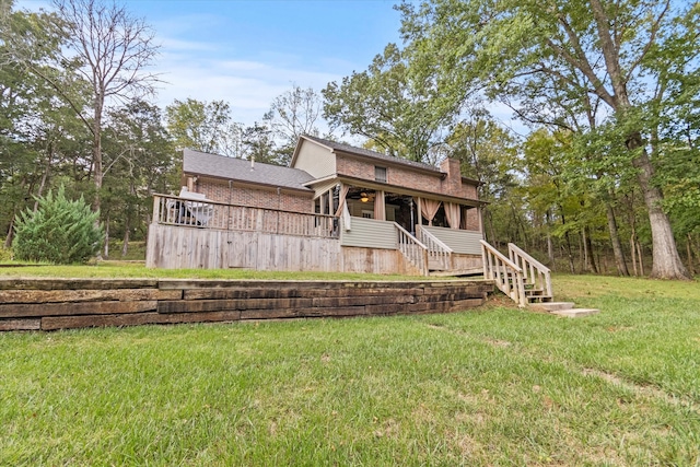 back of property with a yard and a deck