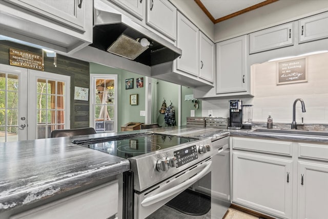 kitchen with stainless steel range with electric cooktop, white cabinets, french doors, and sink