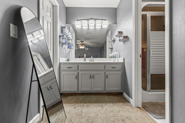 bathroom featuring walk in shower, vanity, and ceiling fan