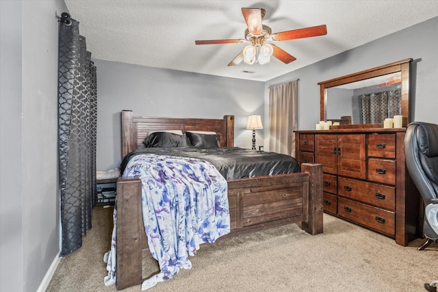 carpeted bedroom with ceiling fan and a textured ceiling